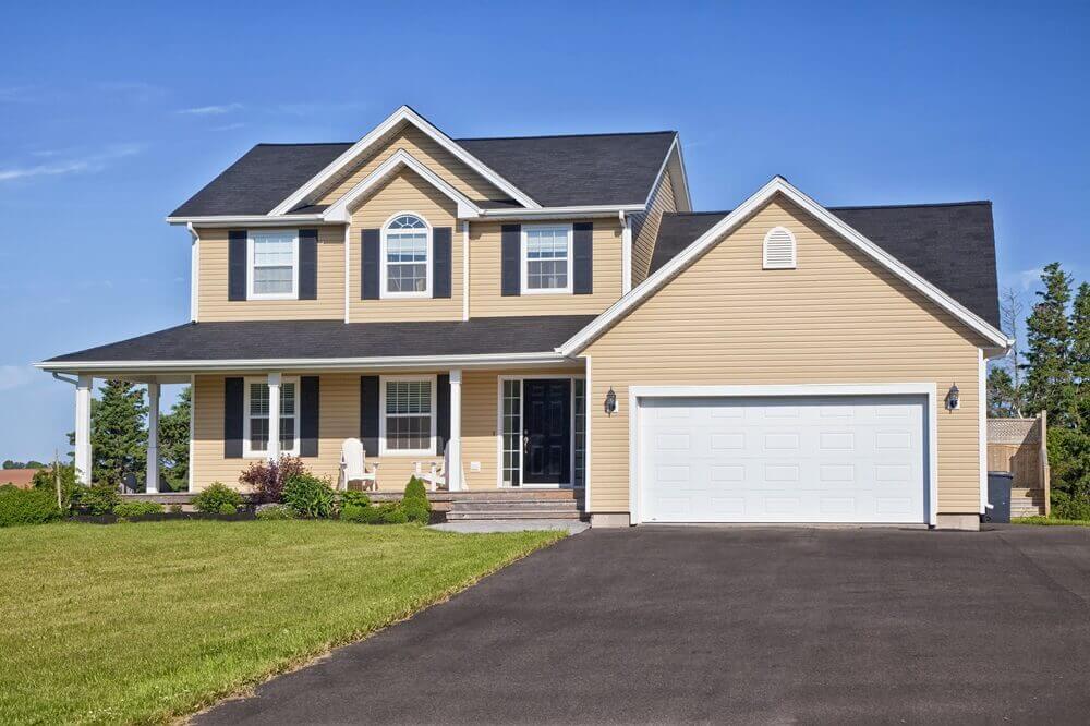 white garage door on house with tan/yellow siding